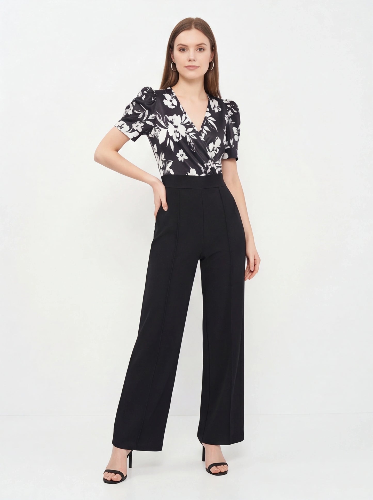 Jamota black floral print jumpsuit with wrap V-neck, short puff sleeves and wide-leg pants.