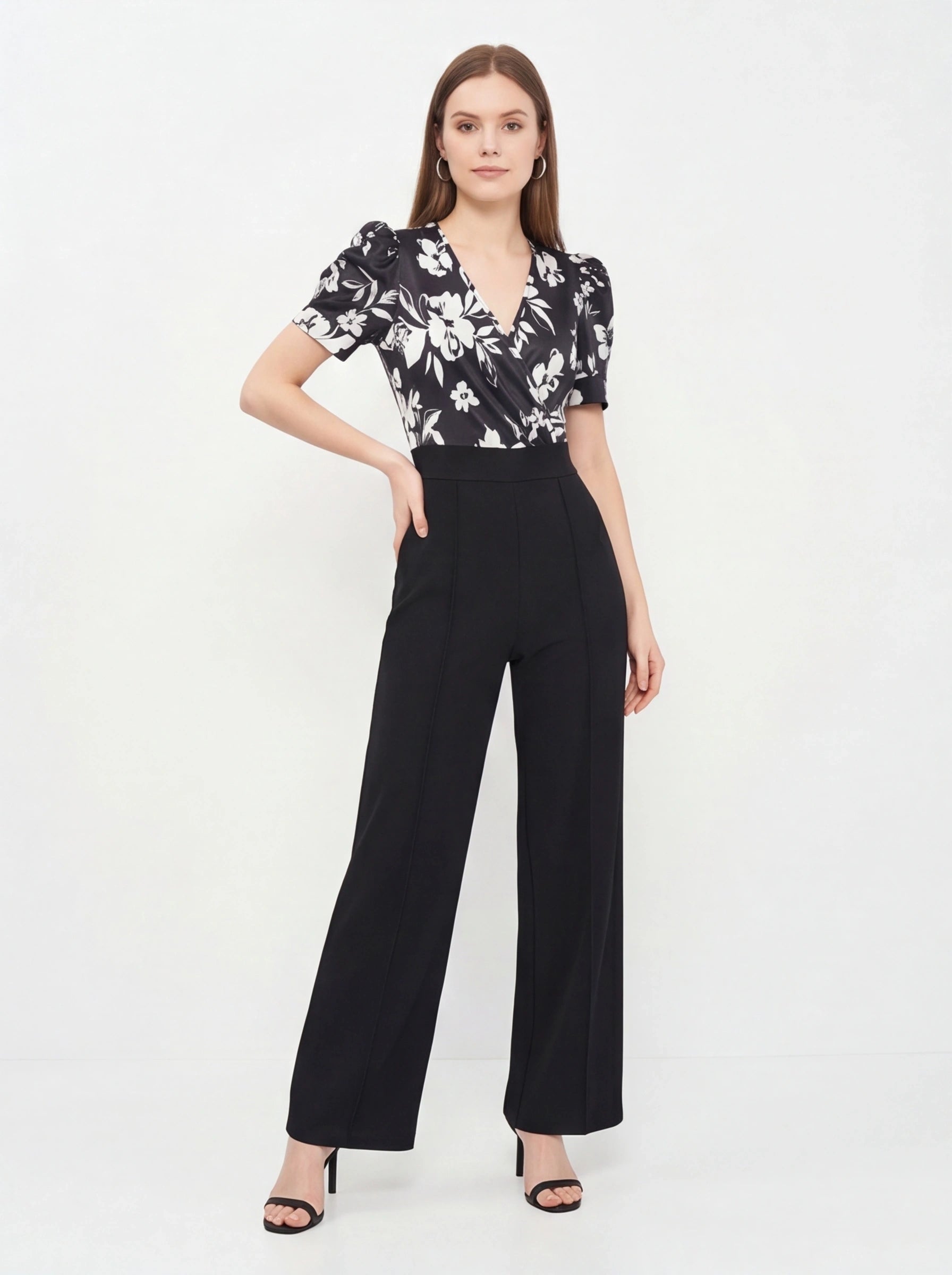 Jamota black floral print jumpsuit with wrap V-neck, short puff sleeves and wide-leg pants.