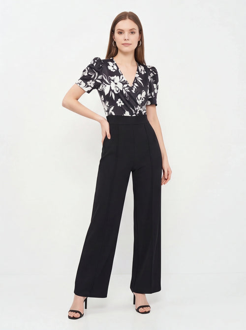 Jamota black floral print jumpsuit with wrap V-neck, short puff sleeves and wide-leg pants.