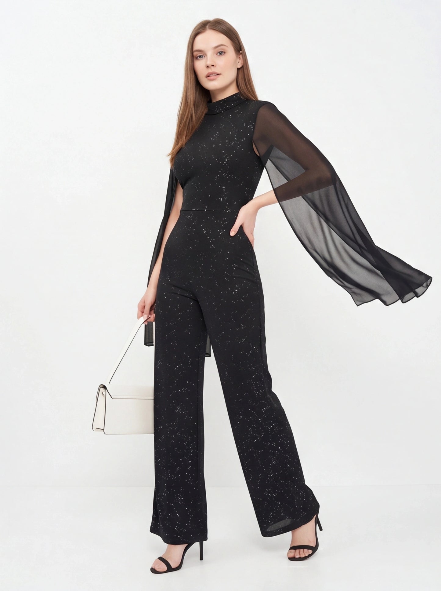 Jamota black glitter jumpsuit with sheer cape sleeves and starry speckled pattern