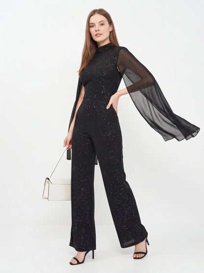 Jamota black glitter jumpsuit with sheer cape sleeves and starry speckled pattern