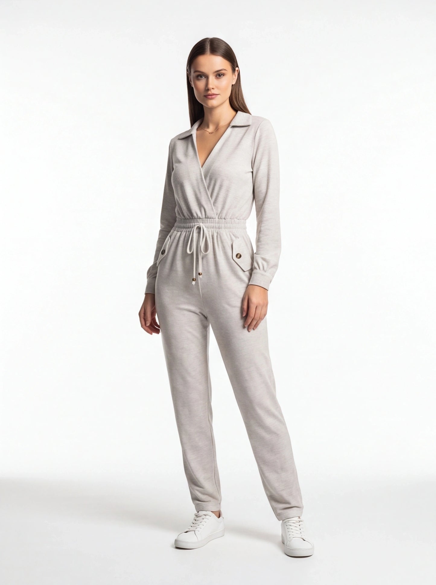 Jamota light gray jumpsuit with wrap-front neckline, elastic drawstring waist, and front pockets with buttoned flaps.