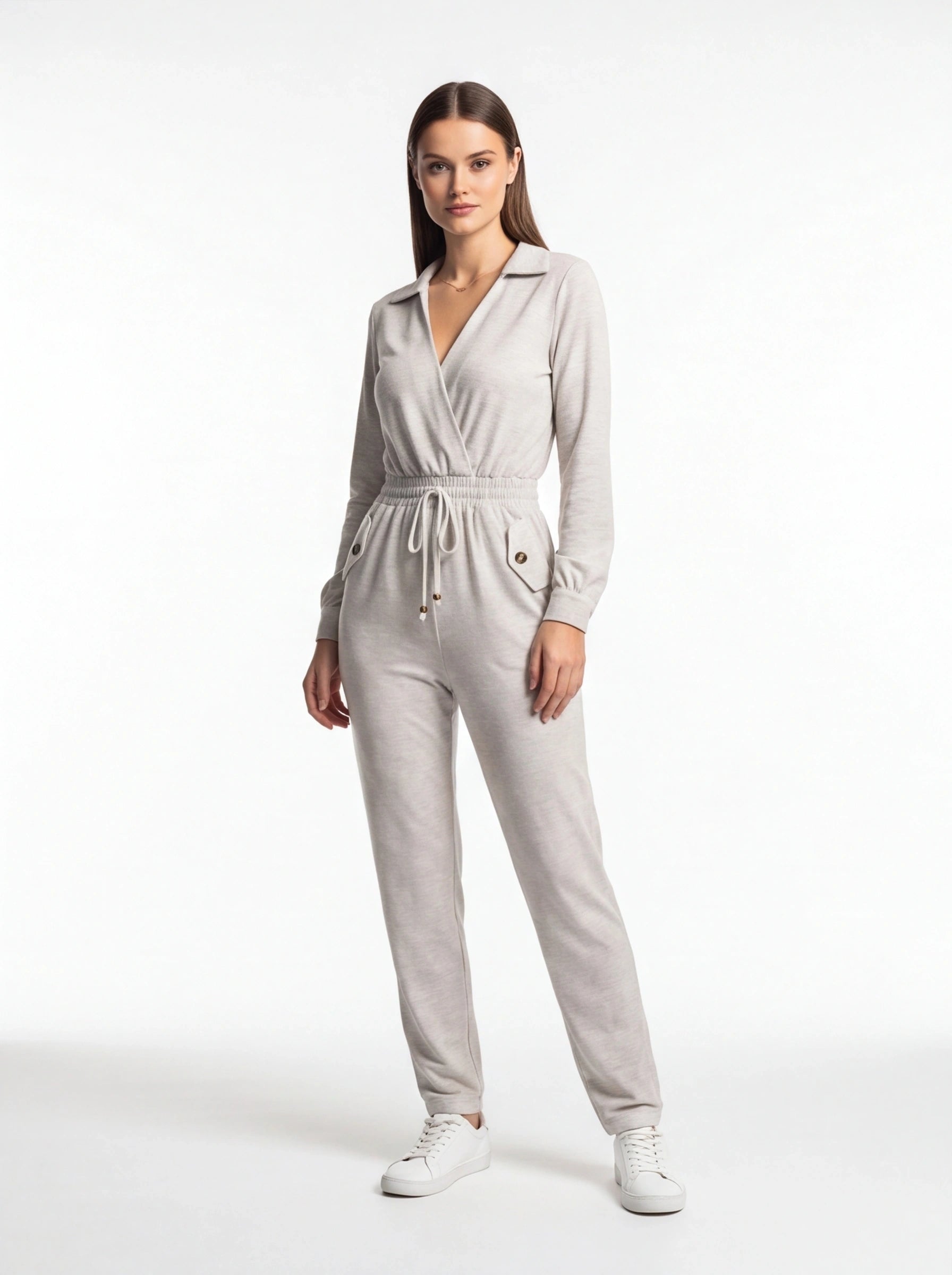 Jamota light gray jumpsuit with wrap-front neckline, elastic drawstring waist, and front pockets with buttoned flaps.