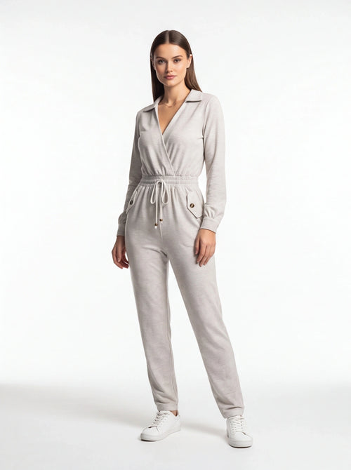 Jamota light gray jumpsuit with wrap-front neckline, elastic drawstring waist, and front pockets with buttoned flaps.