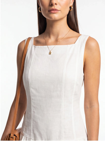 Jamota white sleeveless jumpsuit with square neckline and lightweight fabric; pair with tan handbag and gold jewelry.