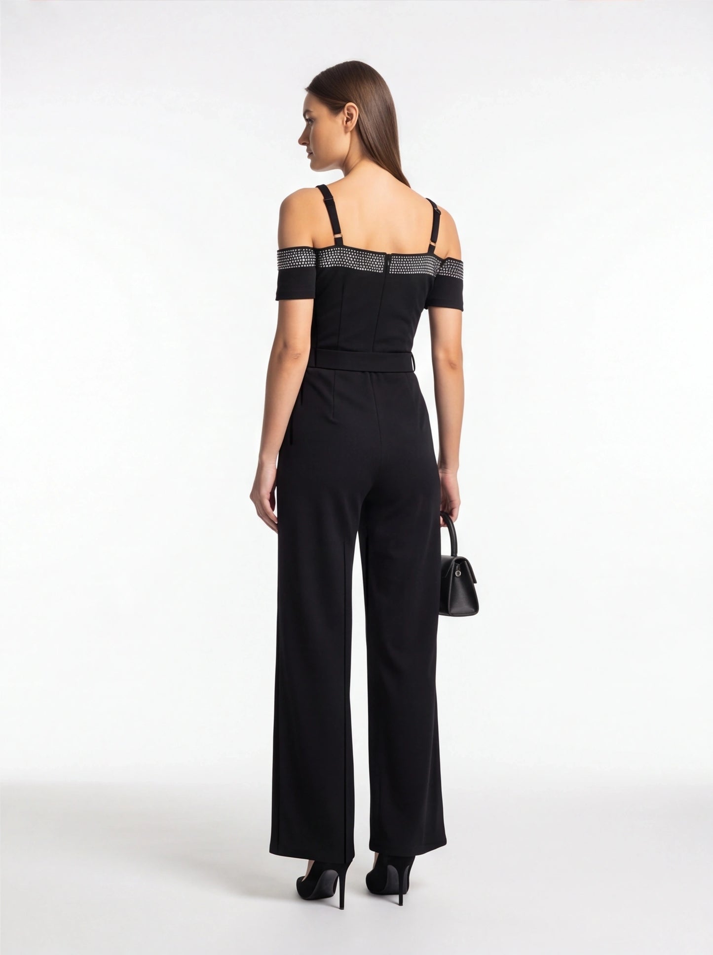 Jamota black jumpsuit with off-shoulder short sleeves, studded band across the upper back, and adjustable straps