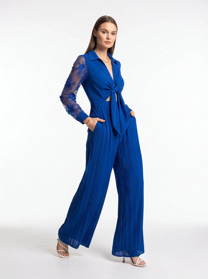 Jamota blue jumpsuit with sheer lace sleeves, knot-front waist and wide pleated legs
