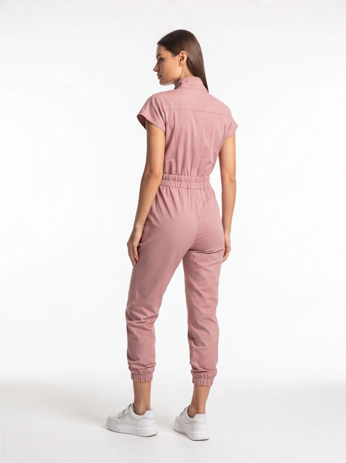 Jamota pink jumpsuit with short sleeves and elastic waist; back view shows tapered legs and a relaxed fit