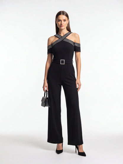 Jamota black women's jumpsuit with off-shoulder neckline, cross-straps, belted waist with square buckle, wide legs.