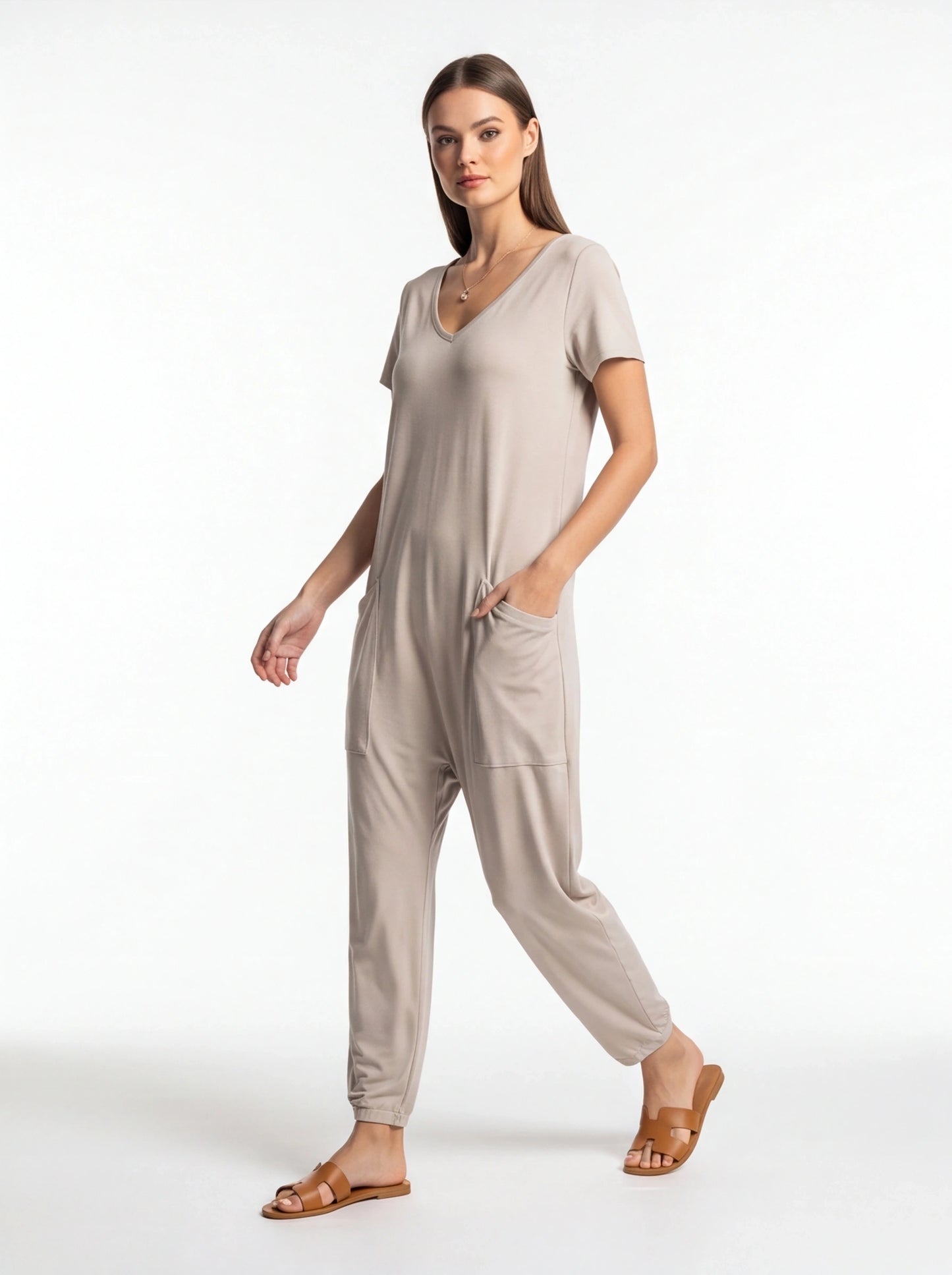 Jamota beige jumpsuit with adjustable straps and pockets, V-neck, relaxed fit.