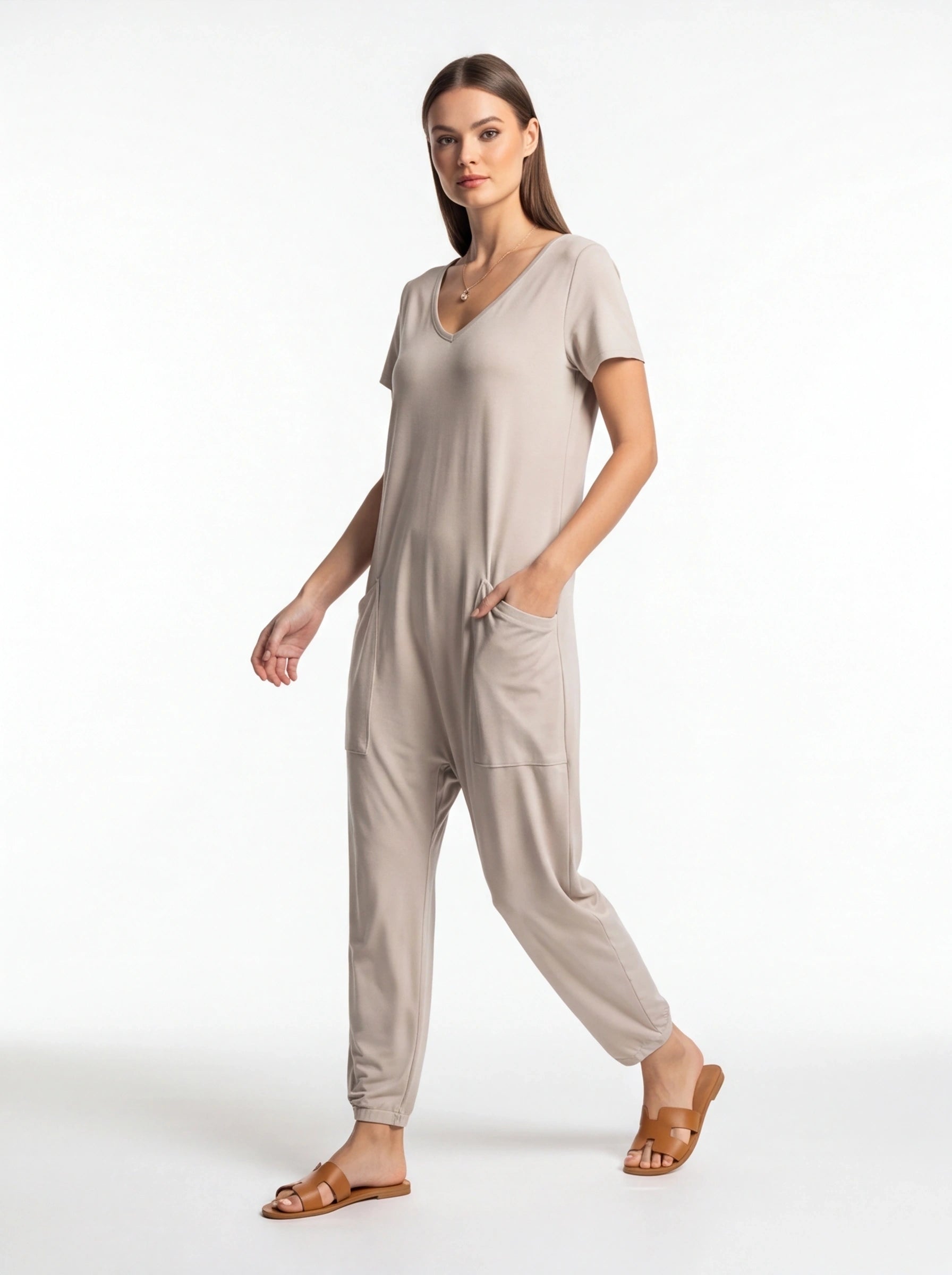 Jamota beige jumpsuit with adjustable straps and pockets, V-neck, relaxed fit.