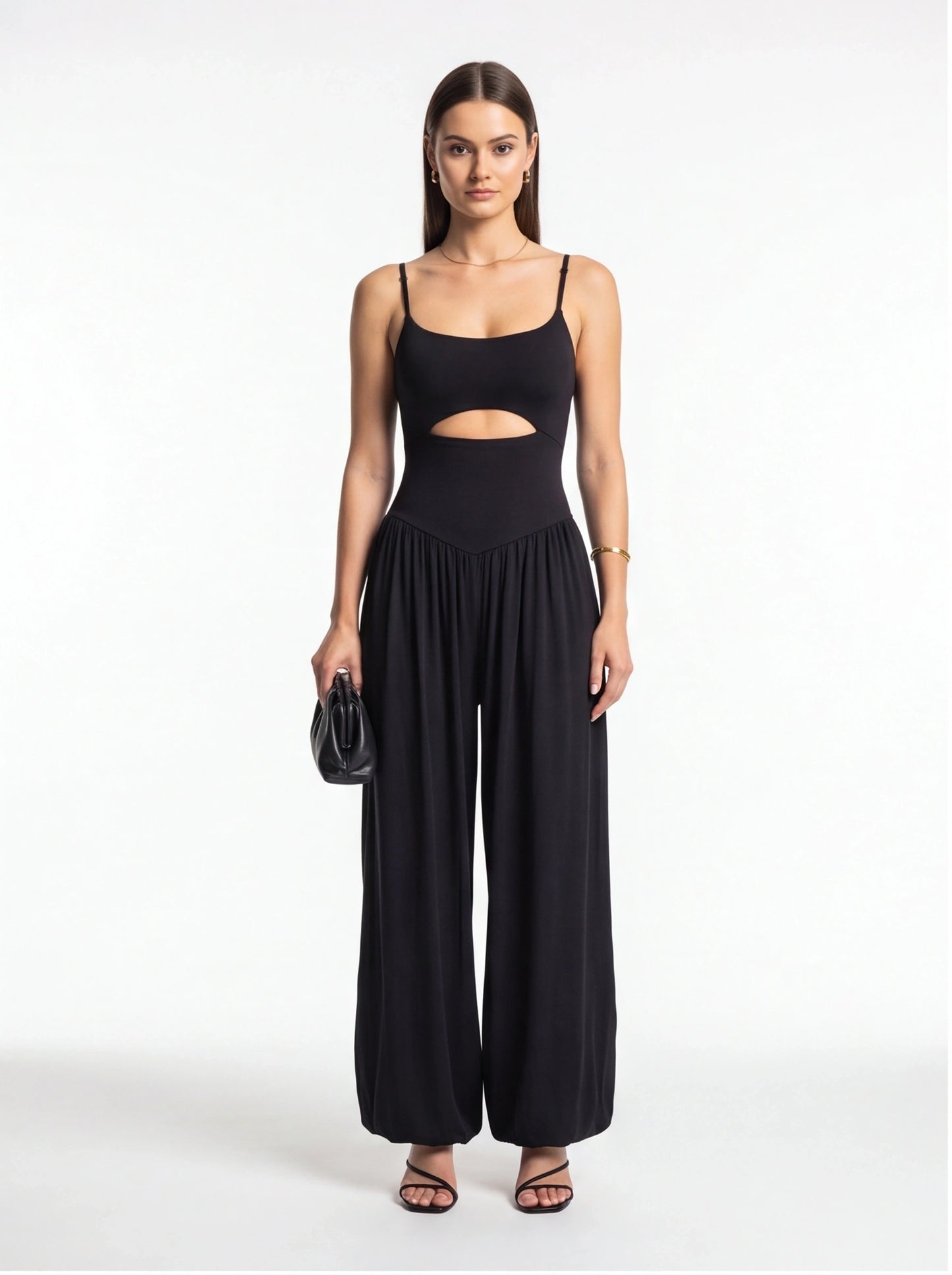 Jamota black jumpsuit with backless midriff cutout, adjustable straps and wide-leg silhouette.