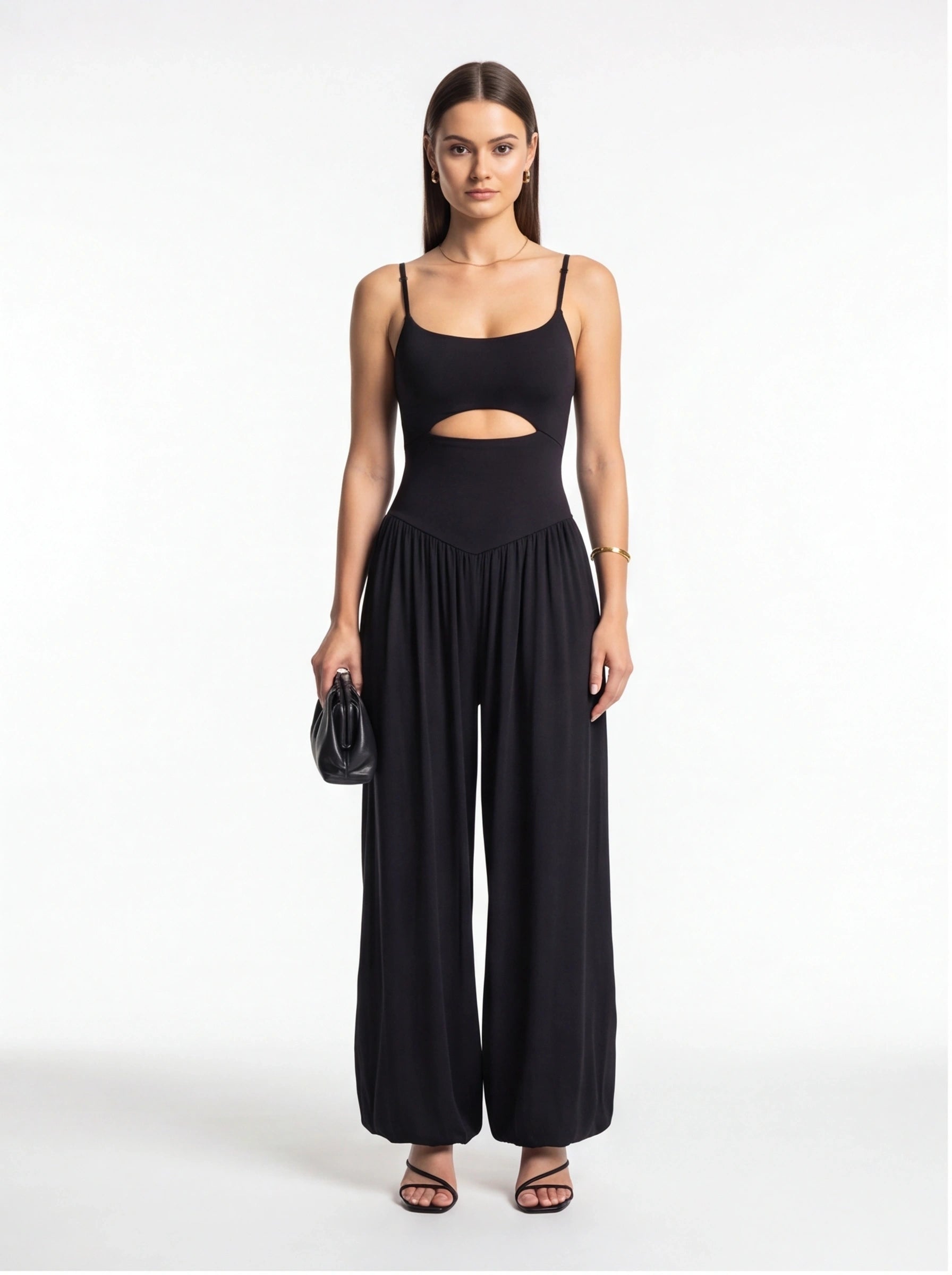 Jamota black jumpsuit with backless midriff cutout, adjustable straps and wide-leg silhouette.