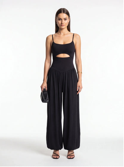 Jamota black jumpsuit with backless midriff cutout, adjustable straps and wide-leg silhouette.