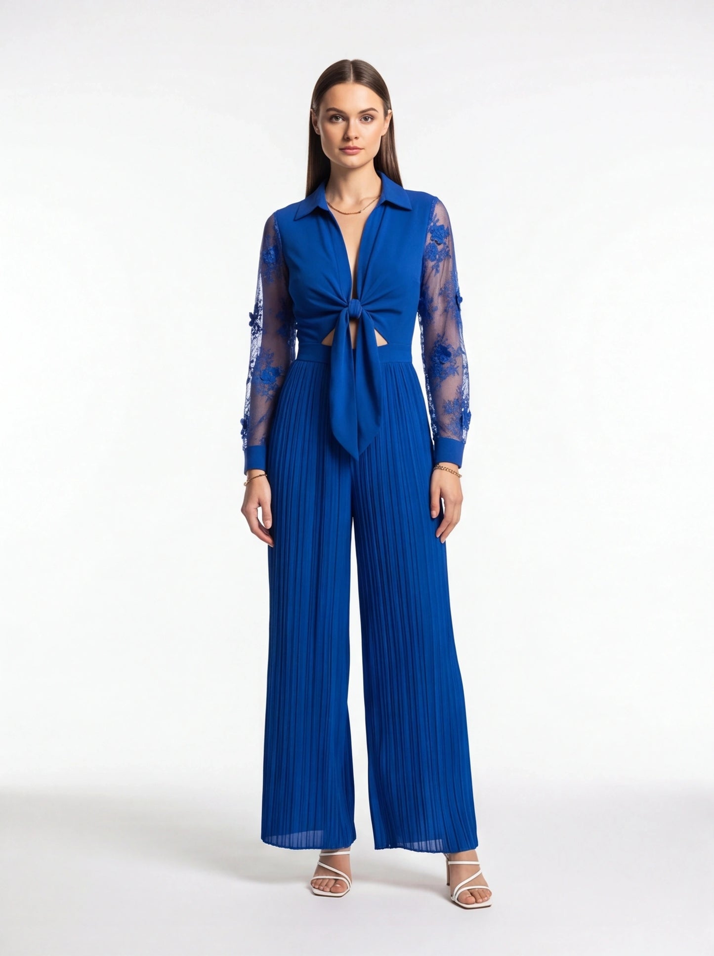 Jamota cobalt blue jumpsuit with sheer lace sleeves, deep V neckline, knotted front and wide pleated legs