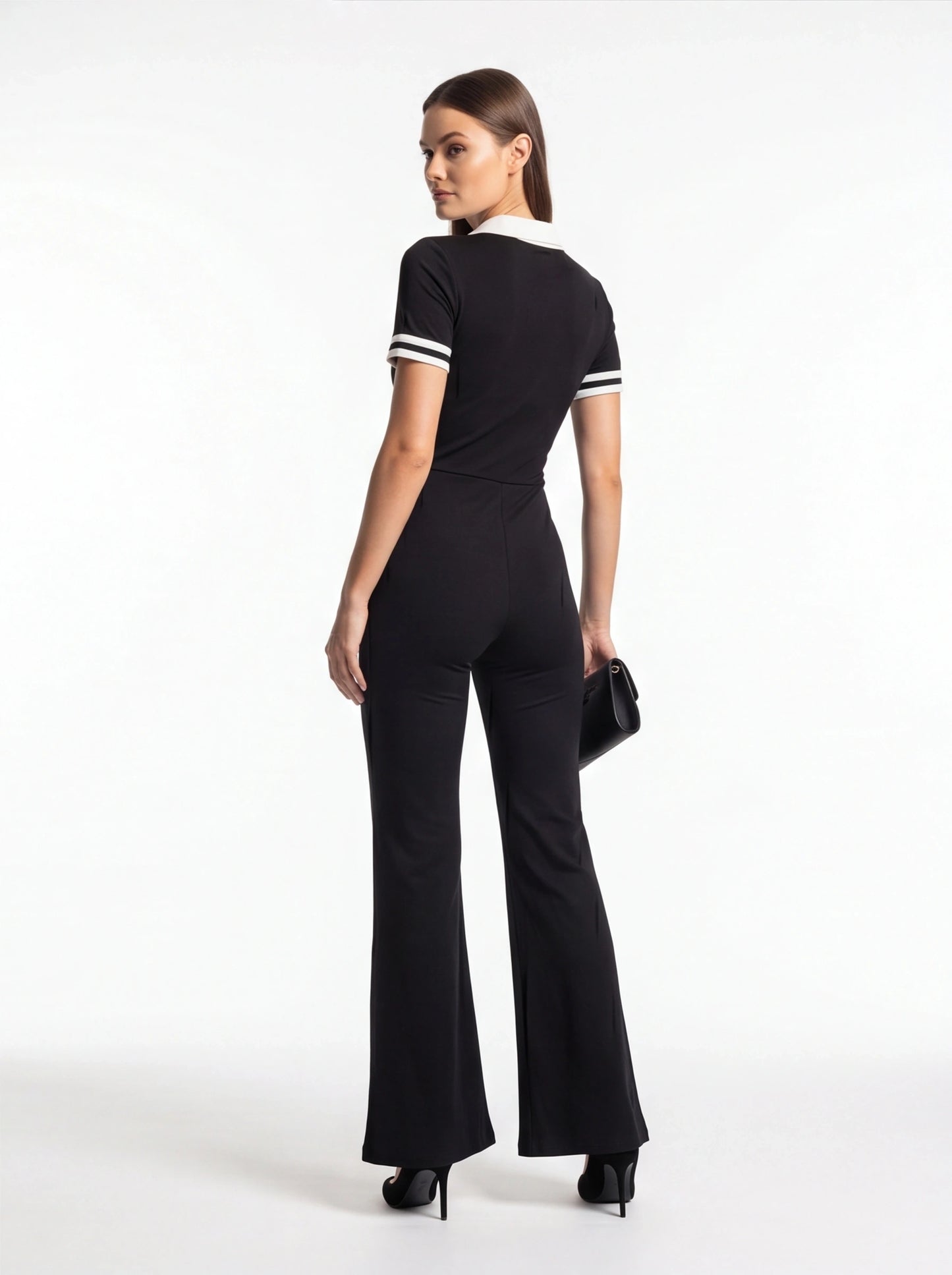 Jamota black women's jumpsuit with white collar and striped sleeve cuffs, flared legs.