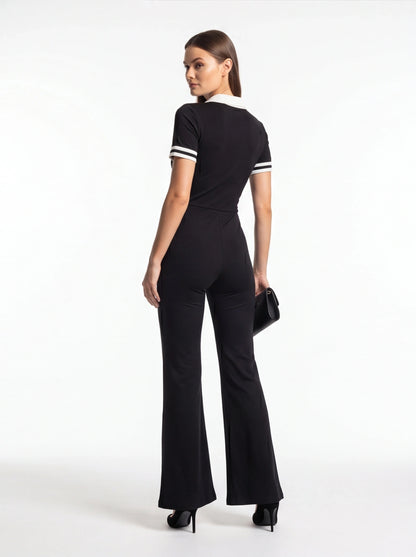 Jamota black women's jumpsuit with white collar and striped sleeve cuffs, flared legs.