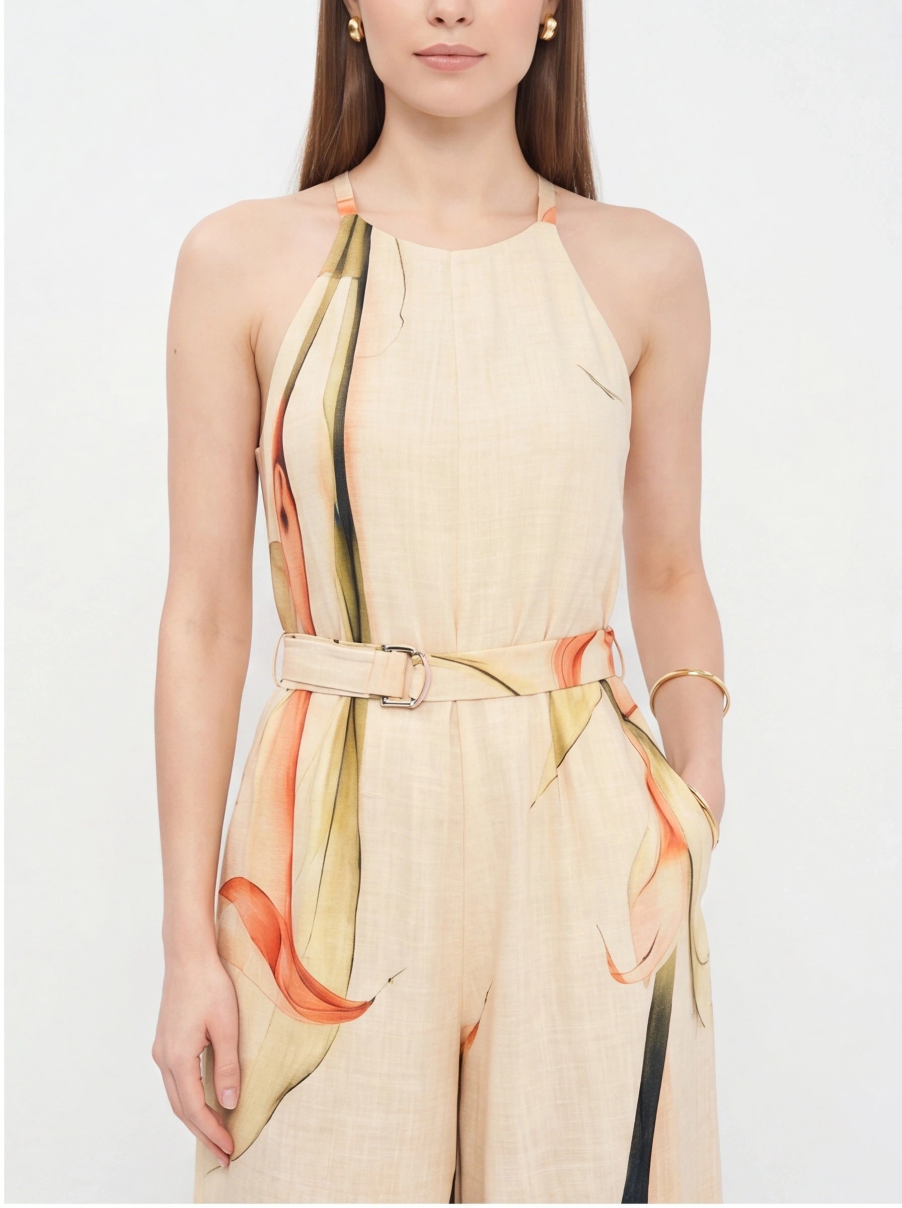 Jamota beige jumpsuit with floral print accents, halter neck straps, wide legs, and waist belt.