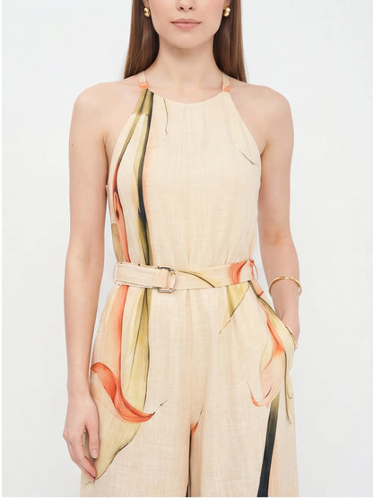 Jamota beige jumpsuit with floral print accents, halter neck straps, wide legs, and waist belt.