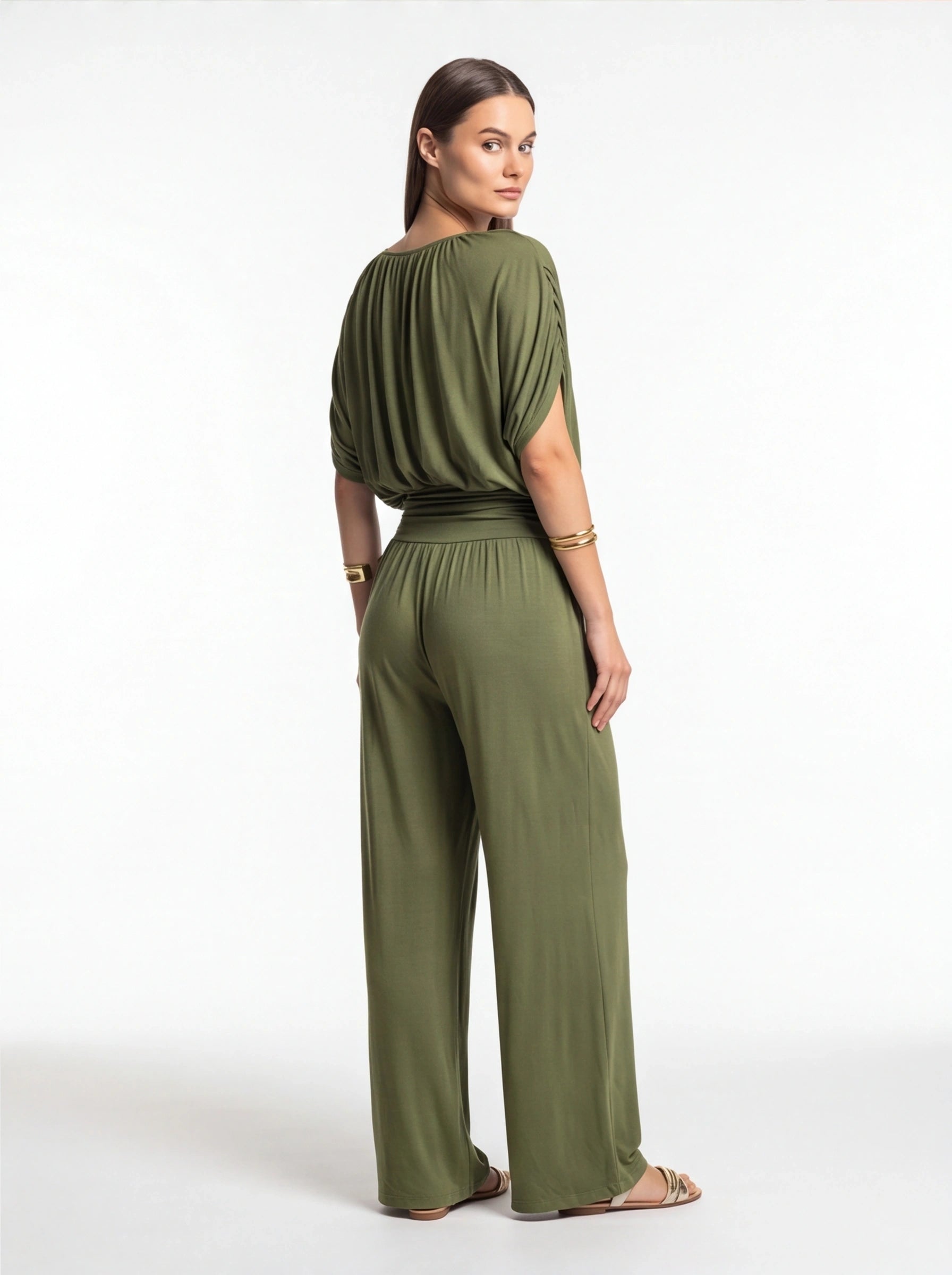 Jamota olive green jumpsuit with a draped top, cinched waist and wide-leg pants, back view.