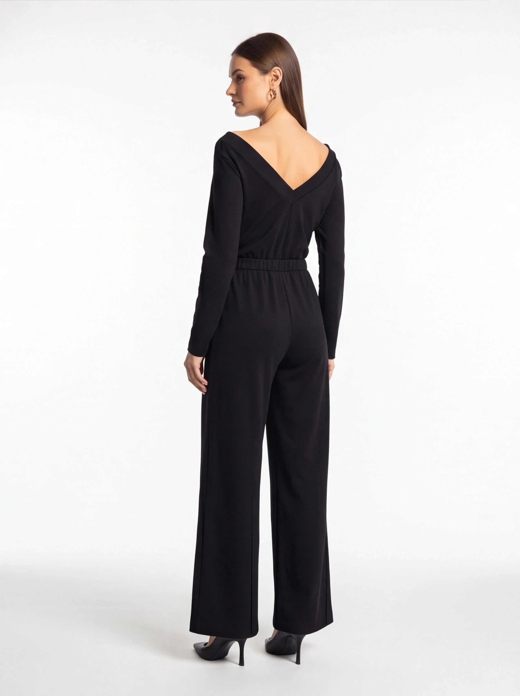 Jamota black jumpsuit with V-back neckline, long sleeves, elastic waist and wide-leg pants.