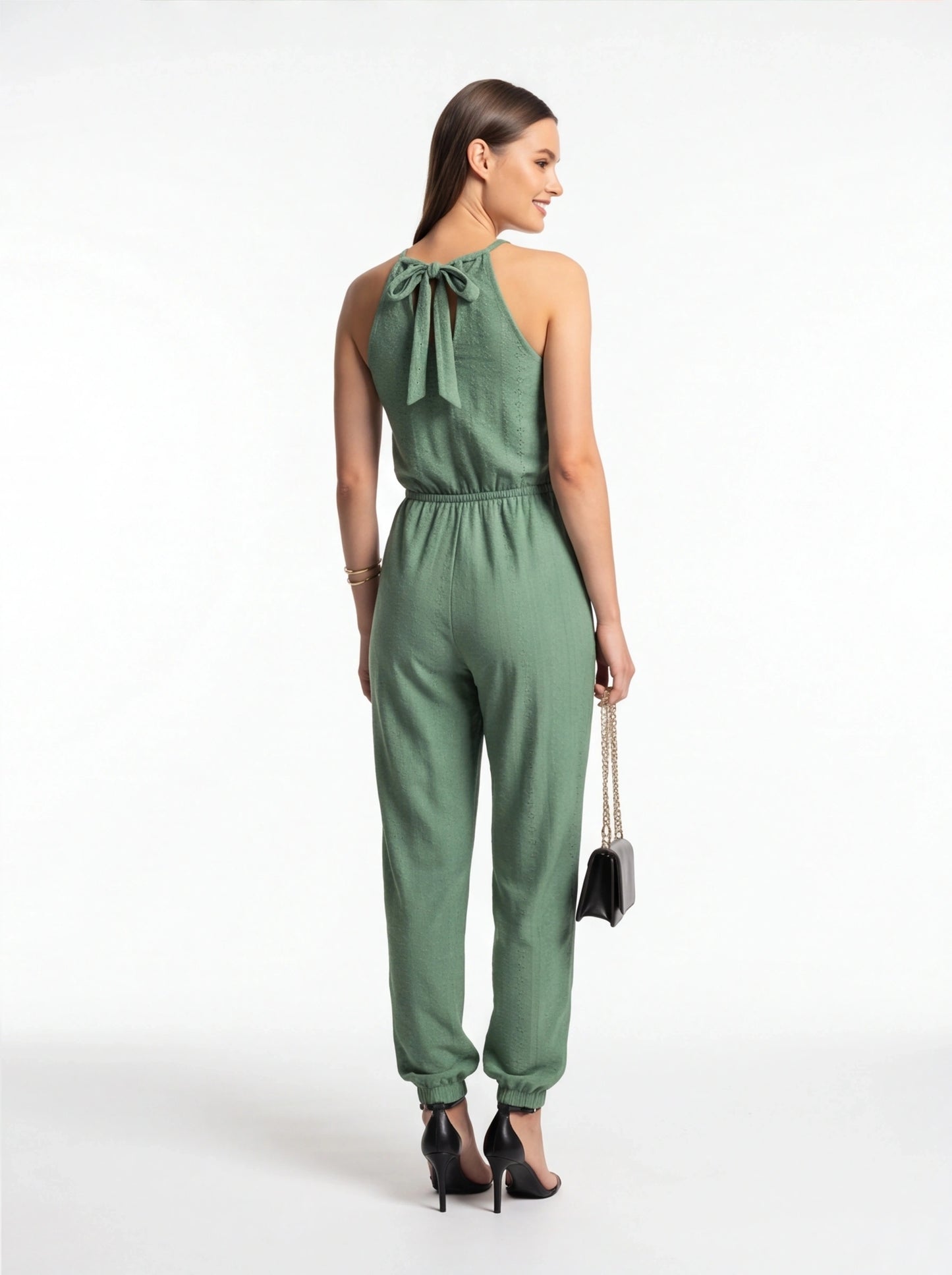 Jamota sage green jumpsuit with back-tie halter neckline and elastic waist; textured fabric and cuffed ankles