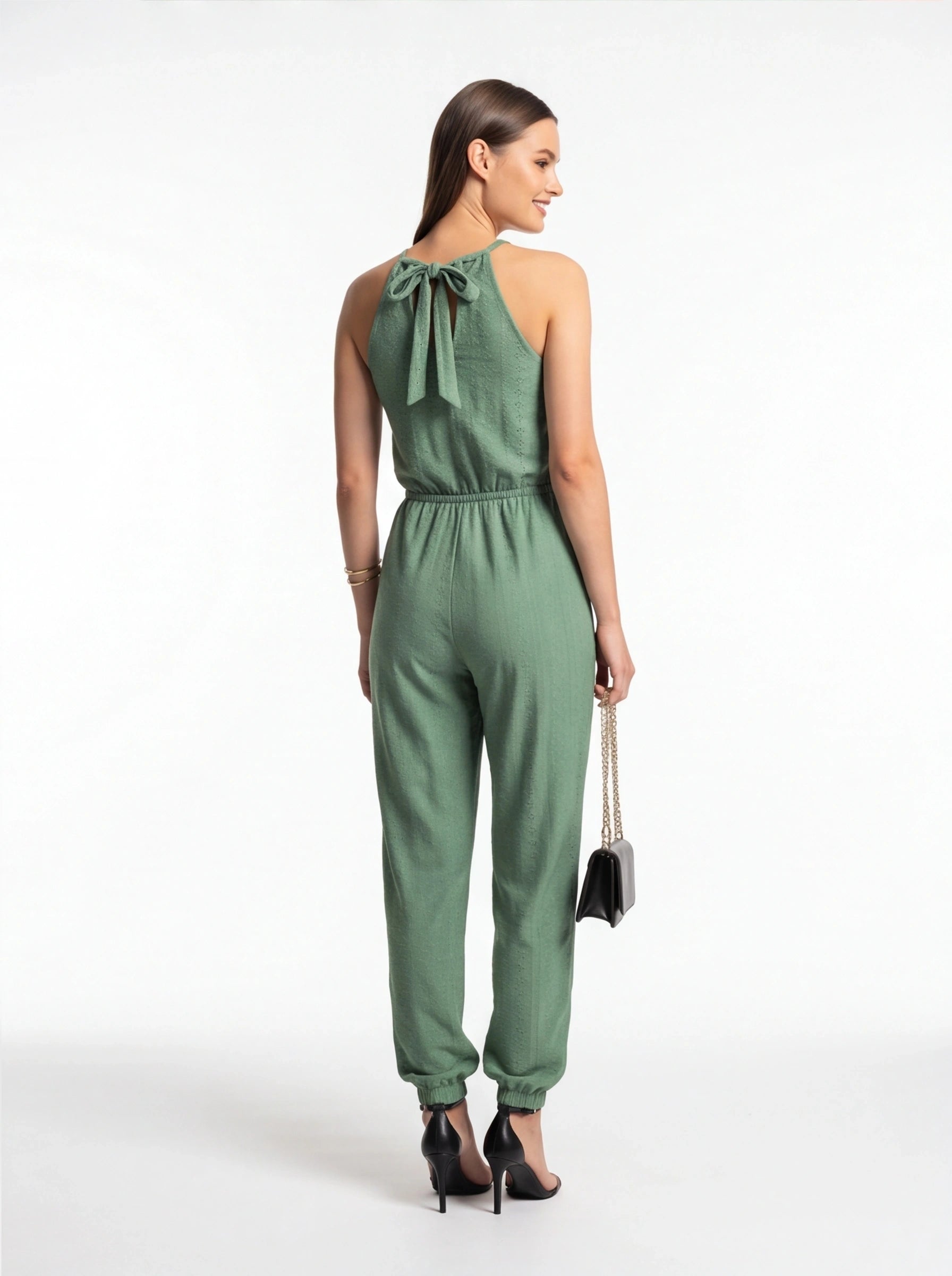 Jamota sage green jumpsuit with back-tie halter neckline and elastic waist; textured fabric and cuffed ankles