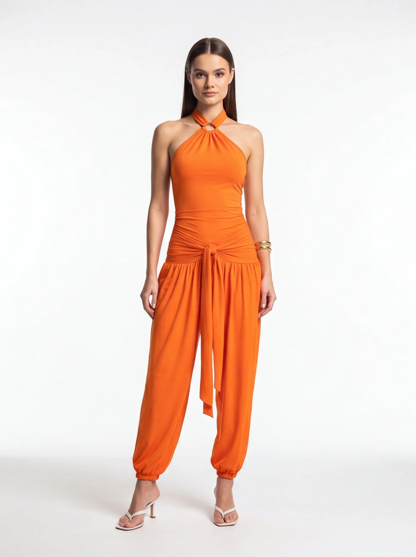 Jamota orange halter jumpsuit with ring neckline, ruched waist and front tie belt, elastic cuffs.