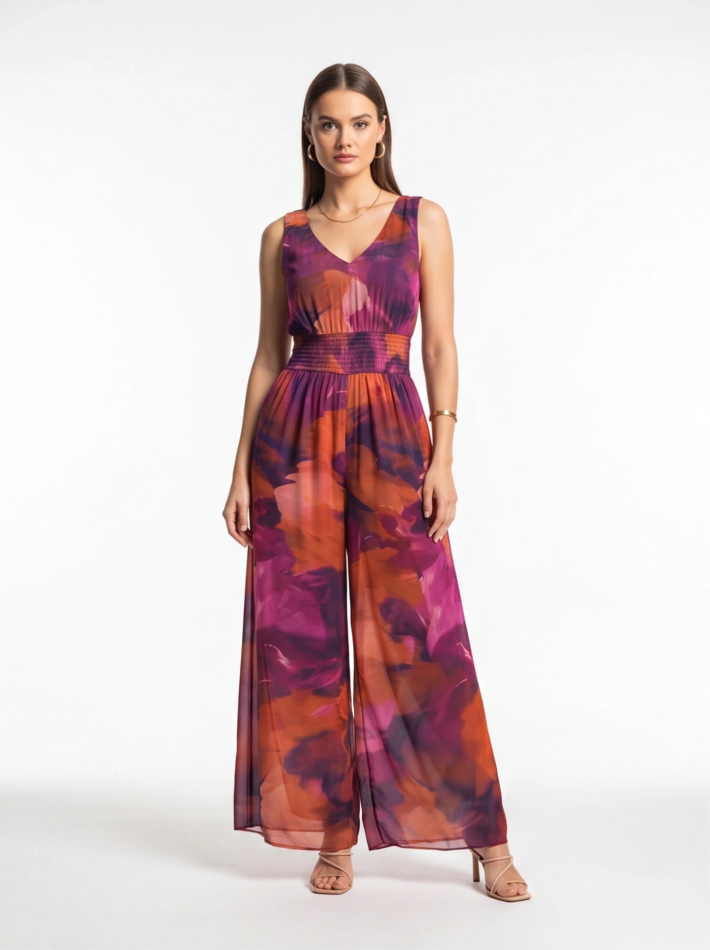 Jamota purple-pink-orange tie-dye jumpsuit with sleeveless V-neck, smocked waist and wide-leg pants.