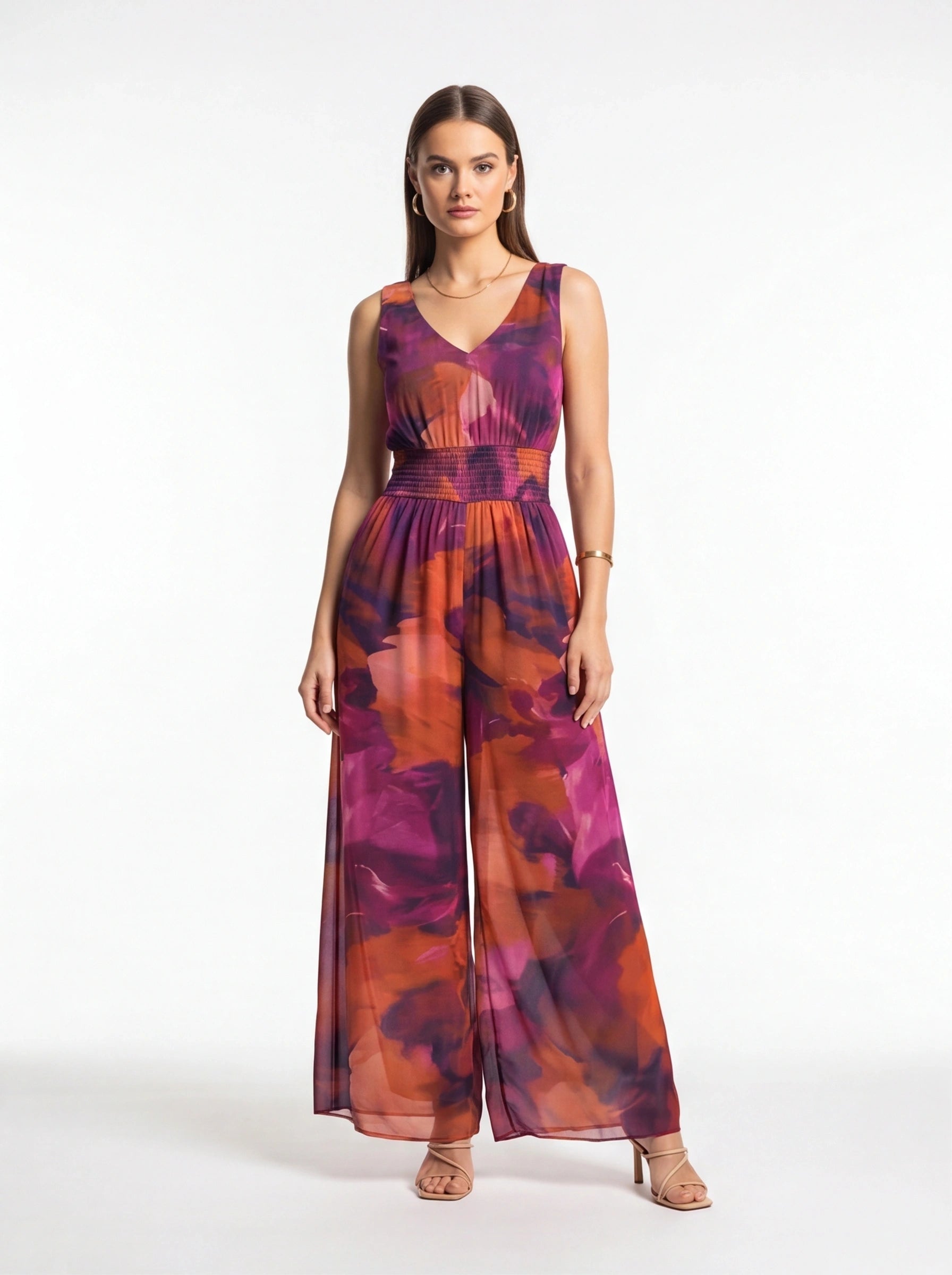 Jamota purple-pink-orange tie-dye jumpsuit with sleeveless V-neck, smocked waist and wide-leg pants.