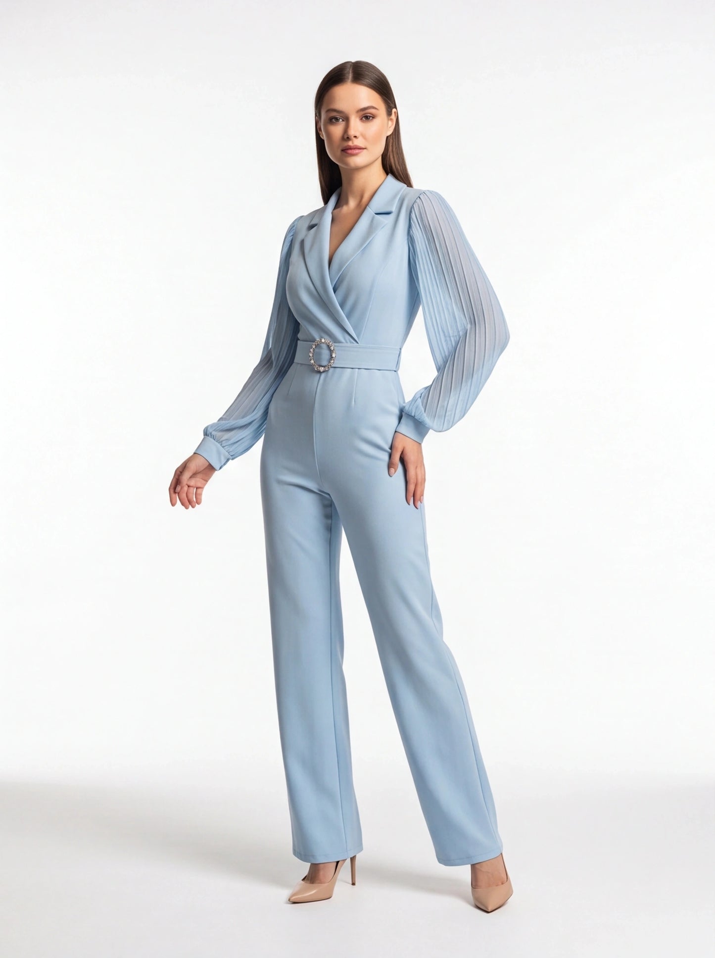 Jamota light blue jumpsuit with pleated sheer long sleeves, structured lapels, and jeweled circular belt buckle.
