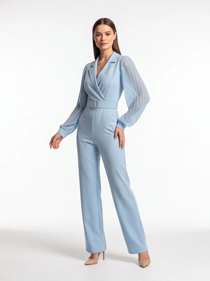 Jamota light blue jumpsuit with pleated sheer long sleeves, structured lapels, and jeweled circular belt buckle.