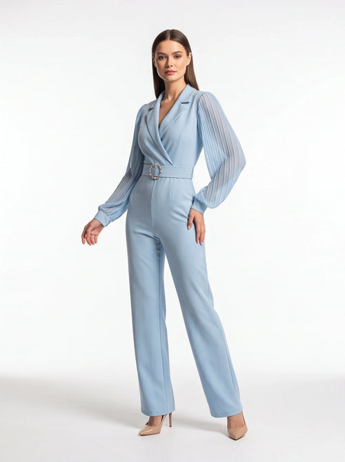 Jamota light blue jumpsuit with pleated sheer long sleeves, structured lapels, and jeweled circular belt buckle.
