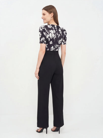 Jamota black floral print jumpsuit with short puff sleeves and wide-leg pants, one-piece silhouette