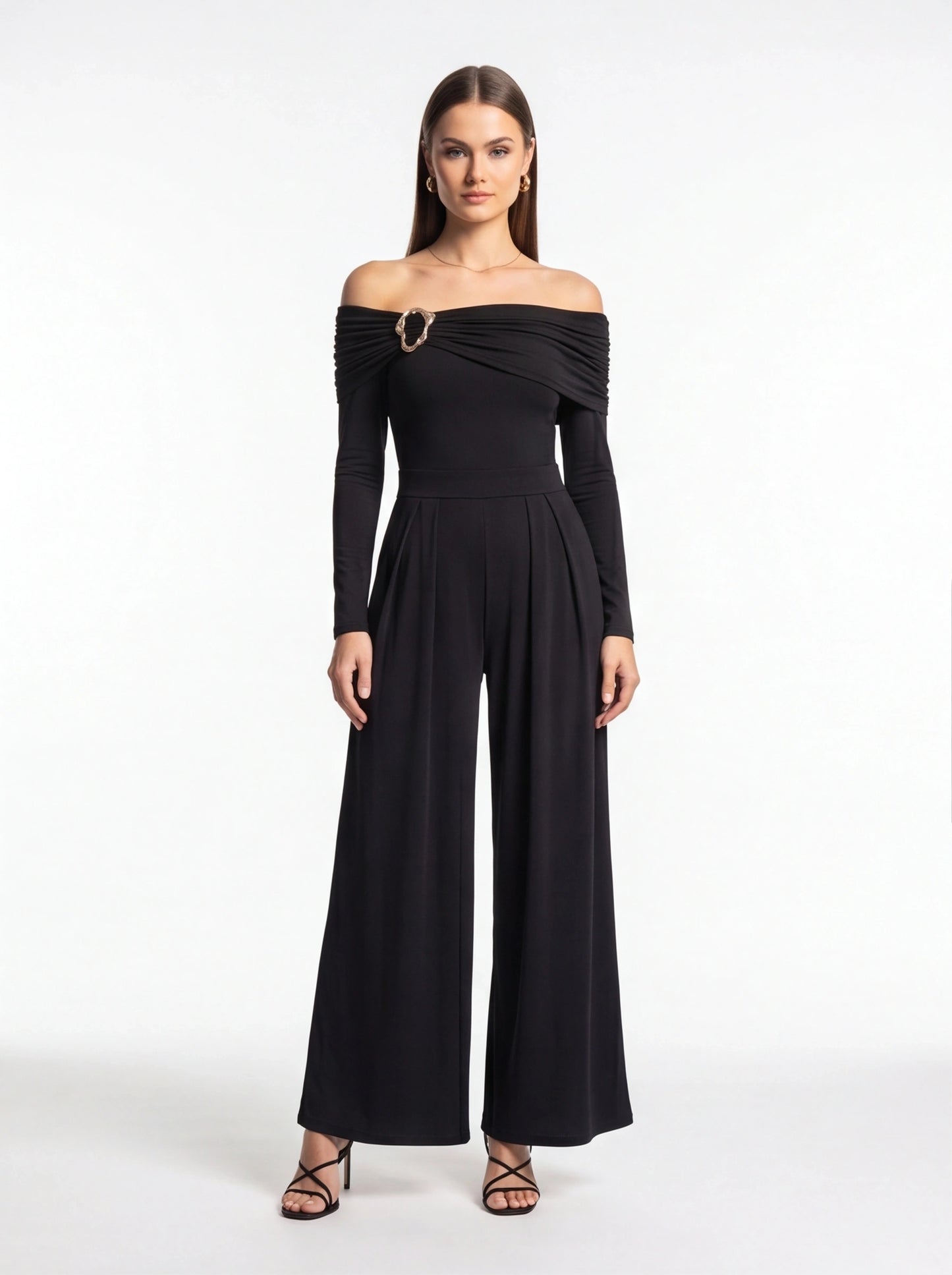 Jamota black off-shoulder jumpsuit with ruched bodice and gold ring brooch, long sleeves and wide-leg pants