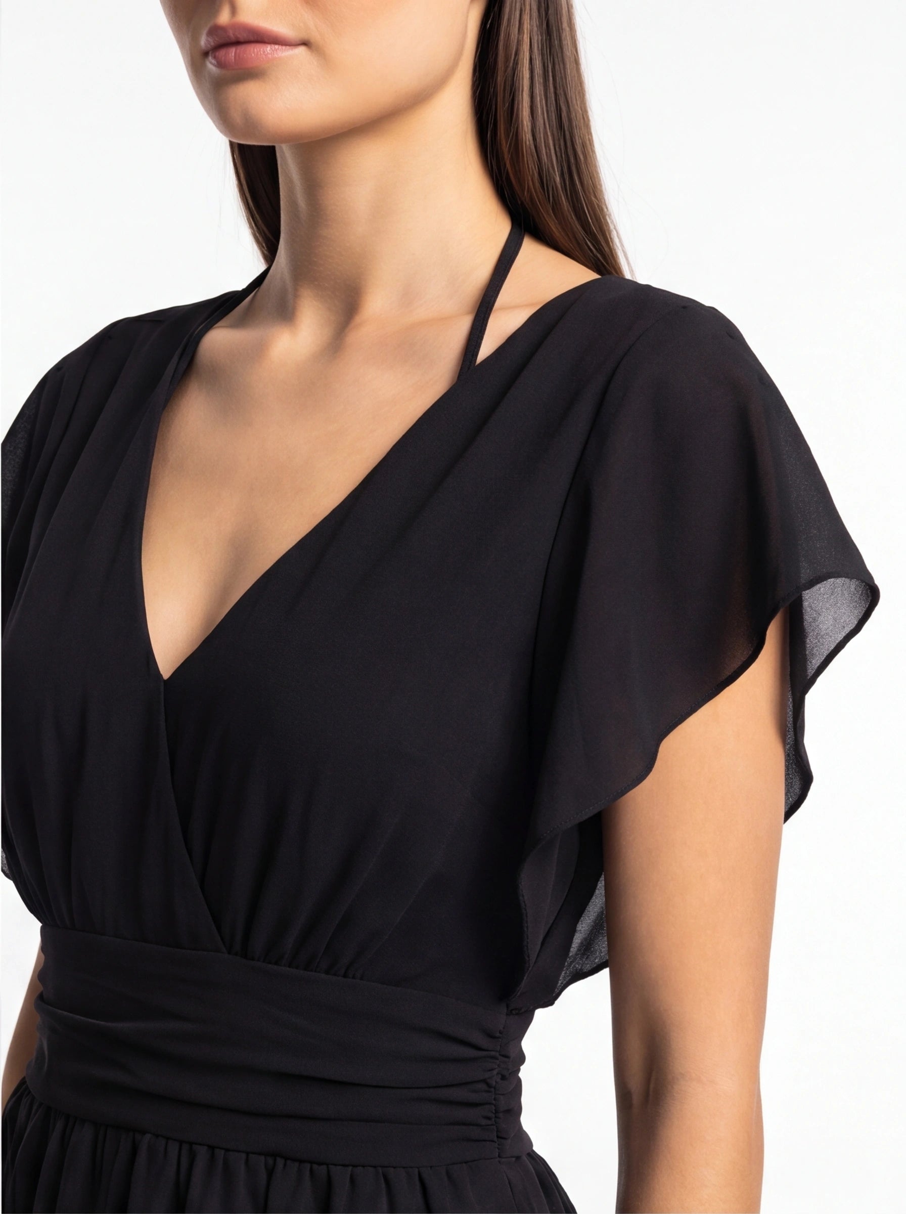 Jamota black romper with halter neck strap, deep V-neck, and flowing draped bodice.