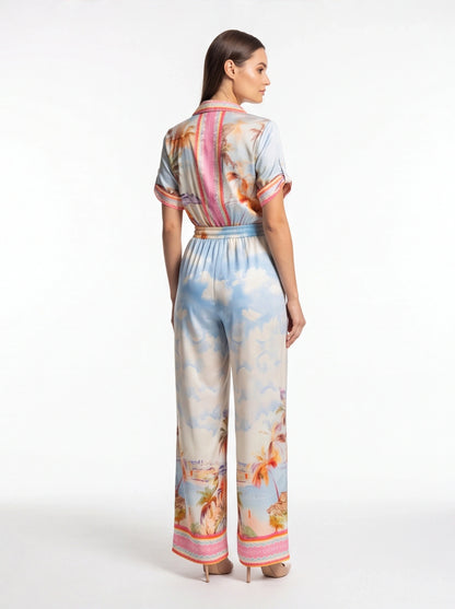 Jamota blue tropical print jumpsuit with short sleeves, elastic waist and pink back stripe detail