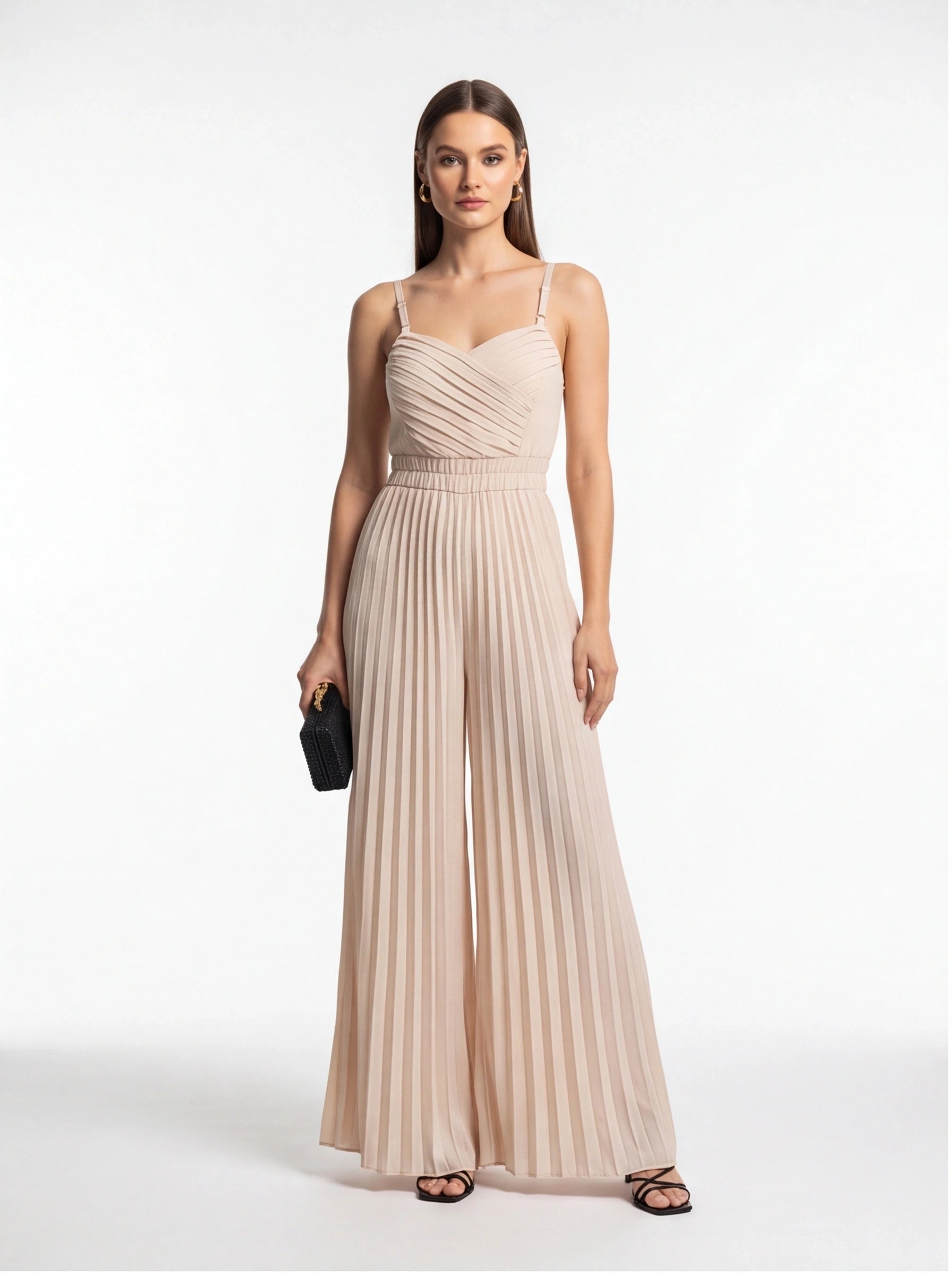 Jamota beige jumpsuit with adjustable straps and a pleated, ruched bodice that flows into wide-leg pants.