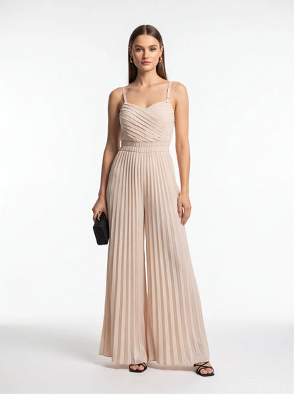 Jamota beige jumpsuit with adjustable straps and a pleated, ruched bodice that flows into wide-leg pants.