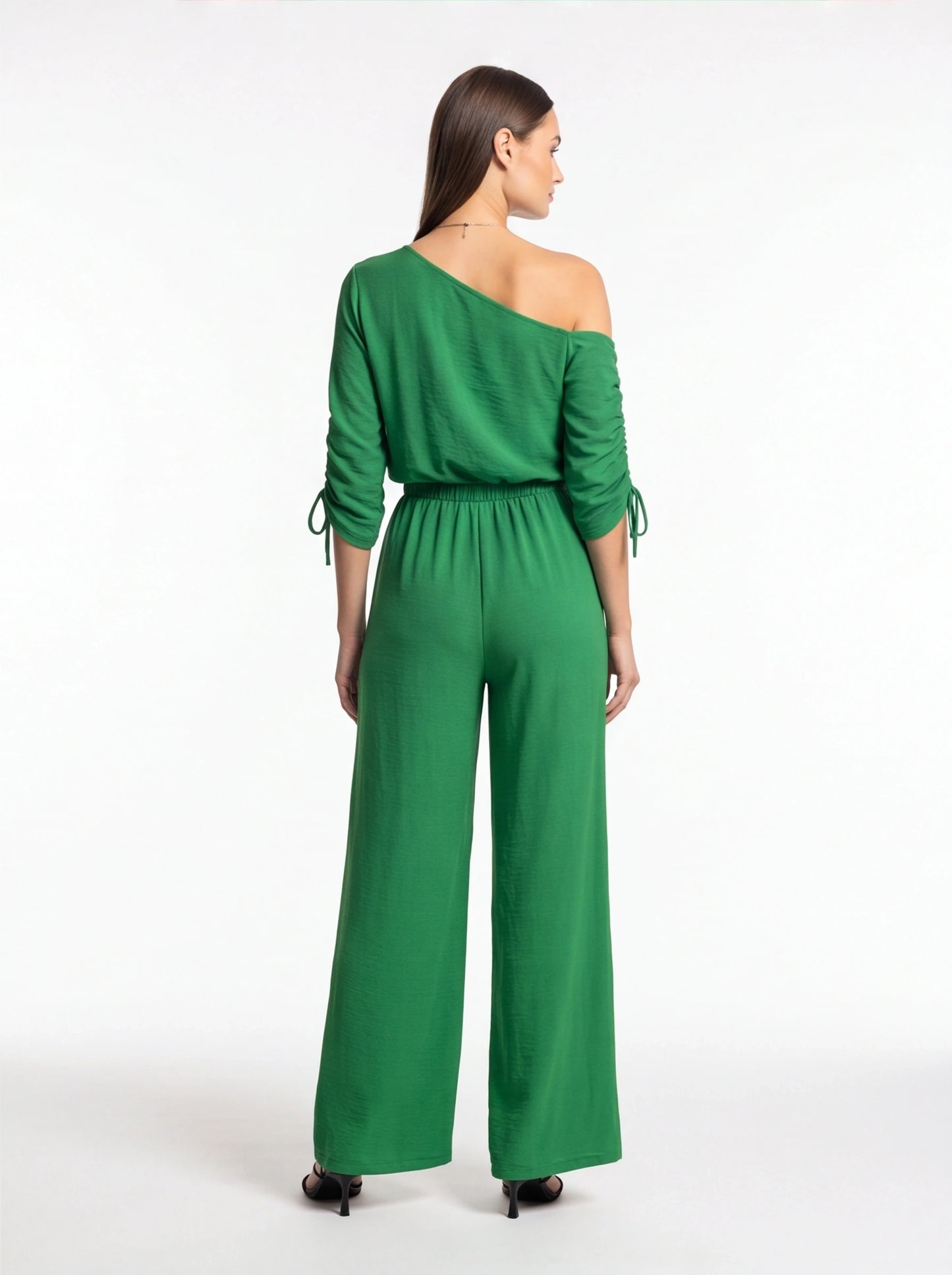 Jamota green wide-leg jumpsuit with one-shoulder neckline and long sleeves with tie cuffs.