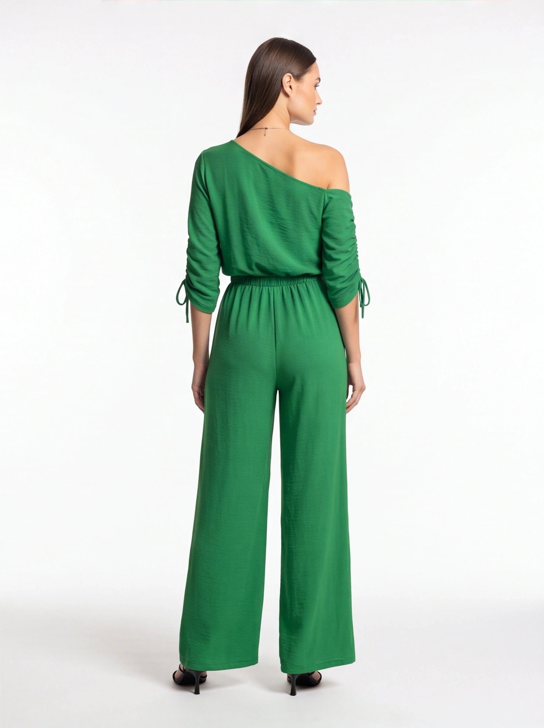Jamota green wide-leg jumpsuit with one-shoulder neckline and long sleeves with tie cuffs.