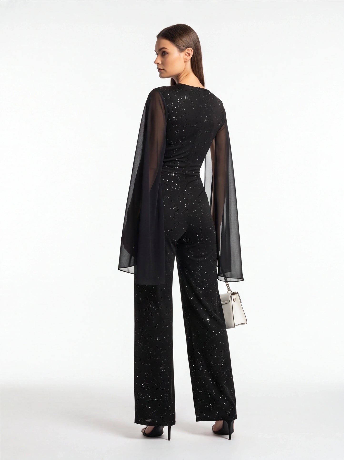 Jamota black jumpsuit with glitter speckled pattern and sheer cape sleeves