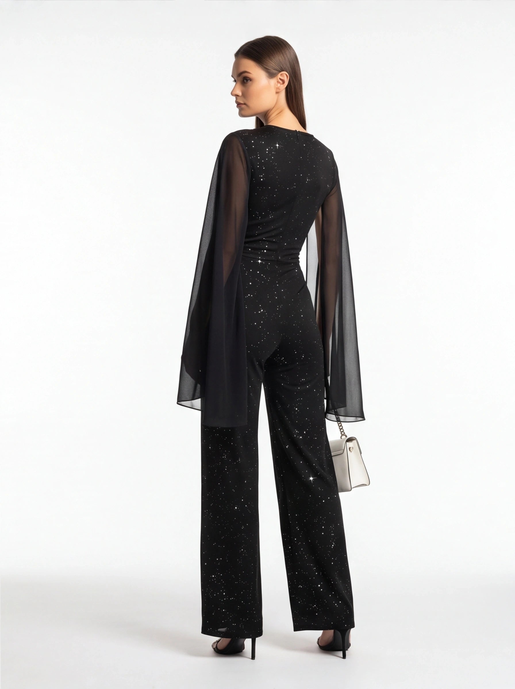 Jamota black jumpsuit with glitter speckled pattern and sheer cape sleeves