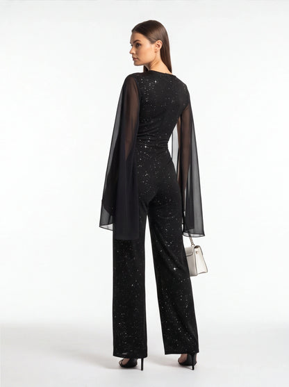 Jamota black jumpsuit with glitter speckled pattern and sheer cape sleeves