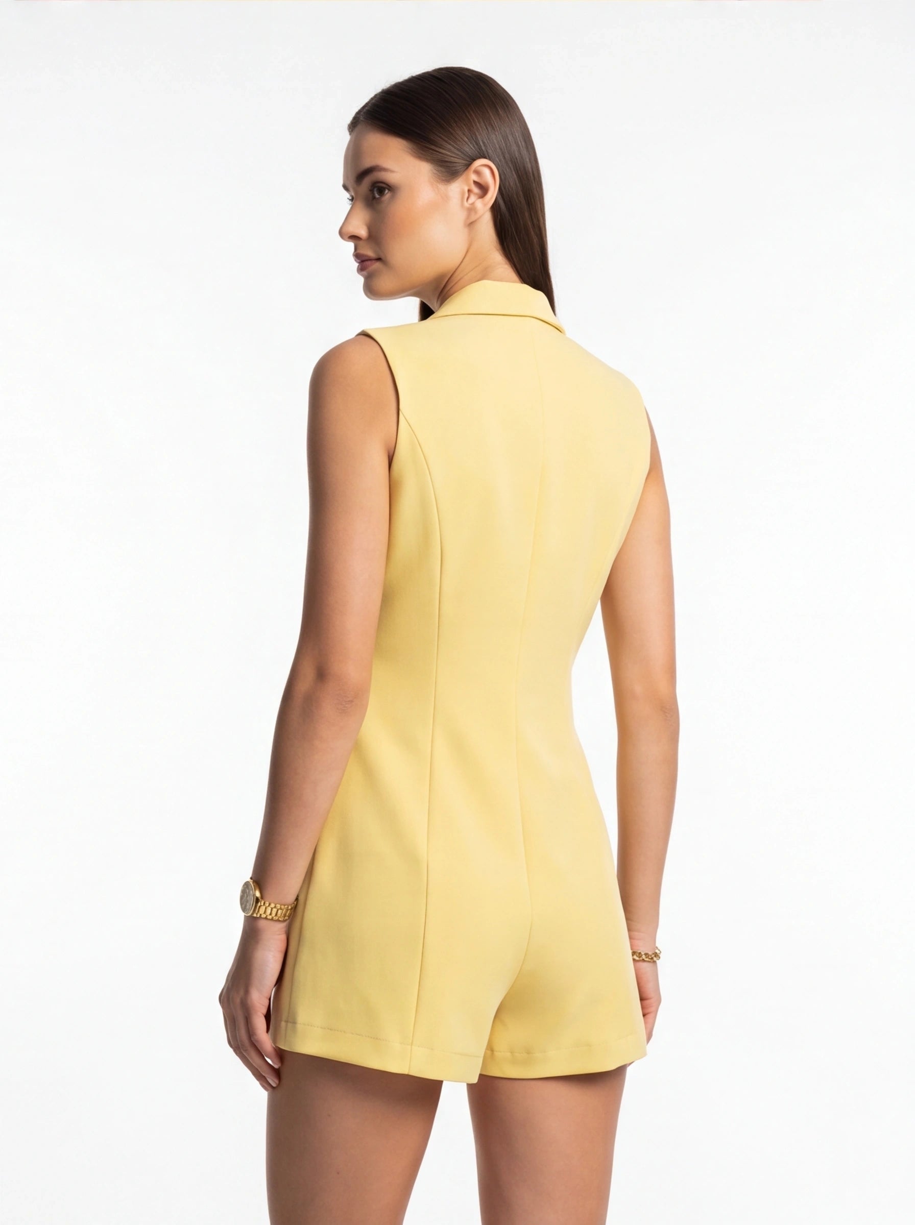 Jamota yellow sleeveless blazer romper with collar and tailored fit, back view on model