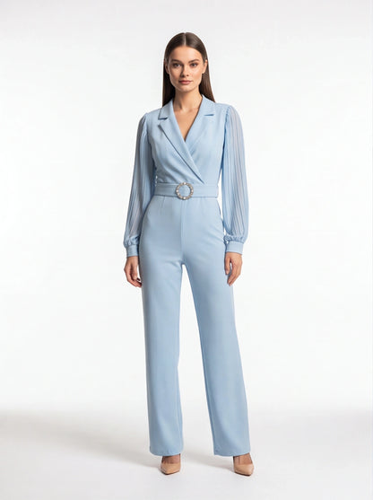 Jamota light blue jumpsuit with a belted waist featuring a circular rhinestone buckle and pleated long sleeves