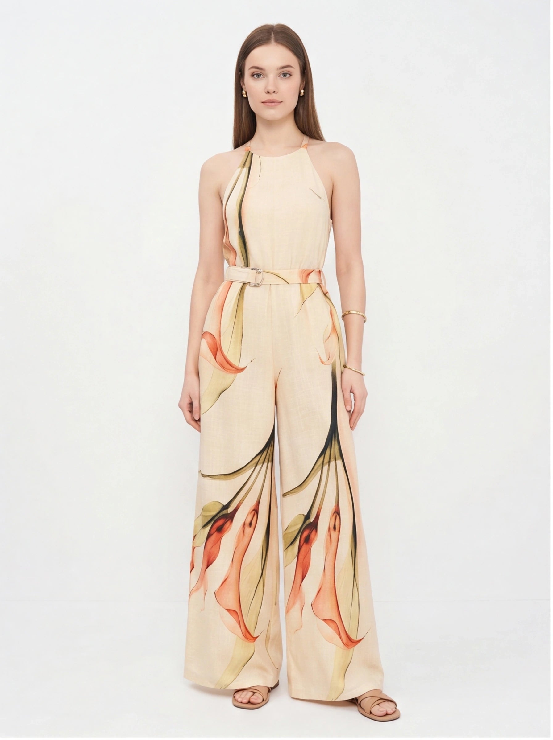 Jamota beige jumpsuit with floral print, halter neck straps, belted waist and wide-leg pants.