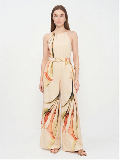 Jamota beige jumpsuit with floral print, halter neck straps, belted waist and wide-leg pants.
