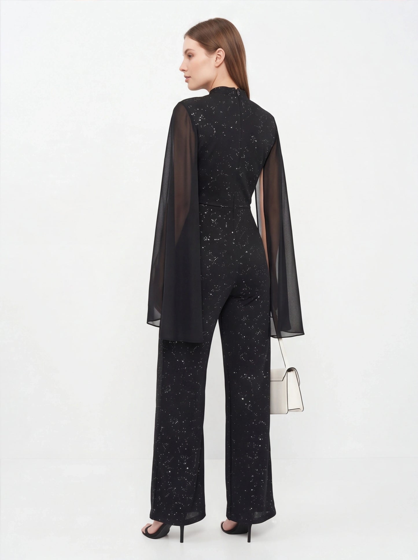 Jamota black glitter chiffon jumpsuit with sheer cape sleeves, back view, wide-leg pants