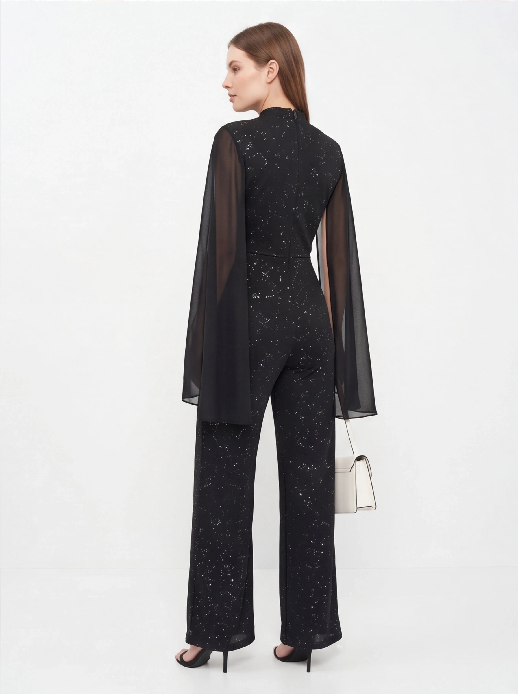 Jamota black glitter chiffon jumpsuit with sheer cape sleeves, back view, wide-leg pants